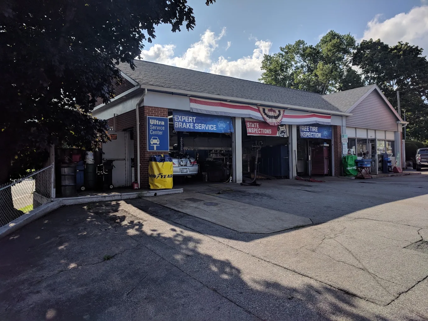 The Pawtuxet Auto Service storefront on Broad Street in Cranston, with open service bays and brake service and state inspection signs